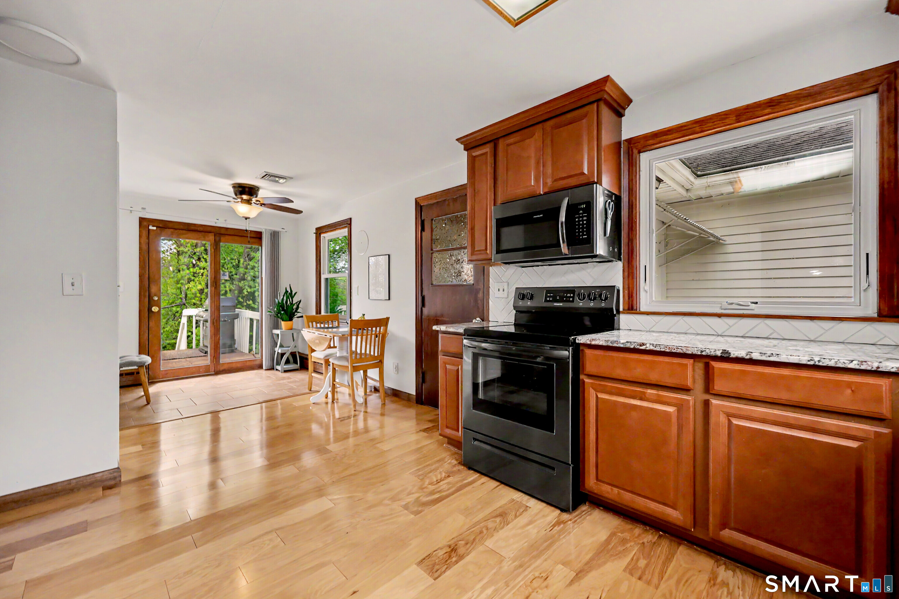 16 Ridgeland Circle Wallingford, CT 06492 - Photo 12 of 30 a kitchen with stainless steel appliances granite countertop a stove a sink and a microwave