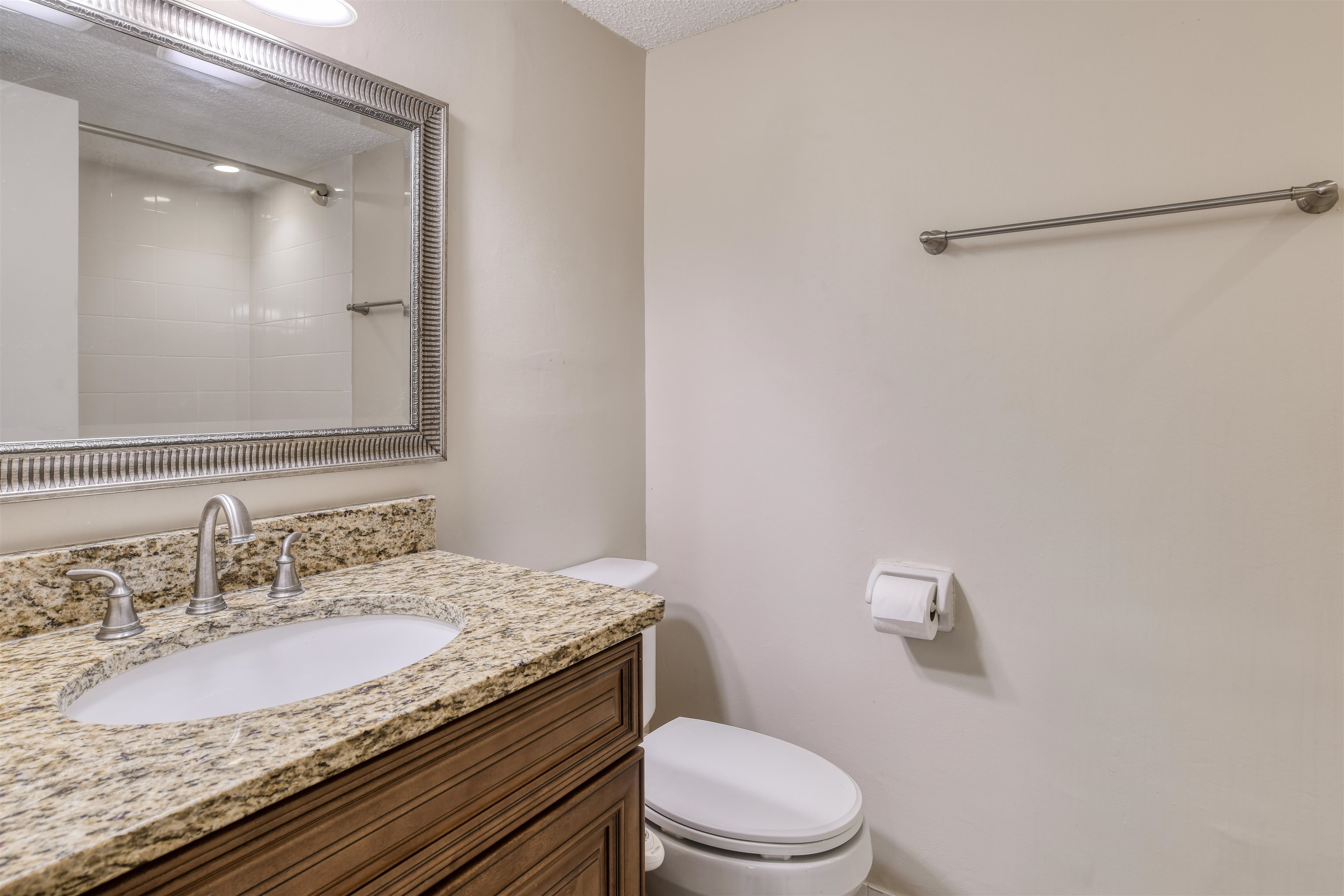 2 Dondanville Road, Unit 101 St. Augustine, FL 32080 - Photo 26 of 50 a bathroom with a granite countertop sink and a mirror