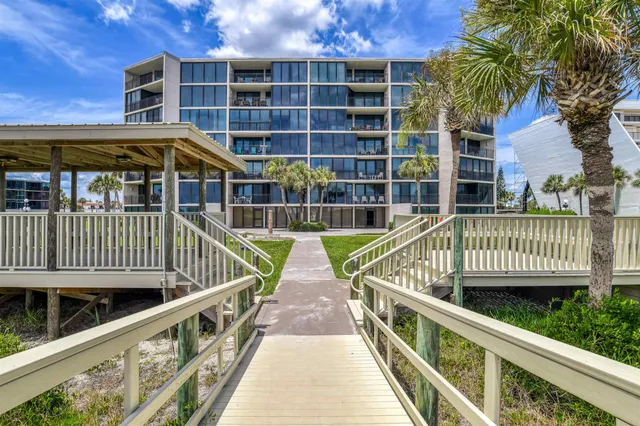 a view of a balcony with wooden floor and fence