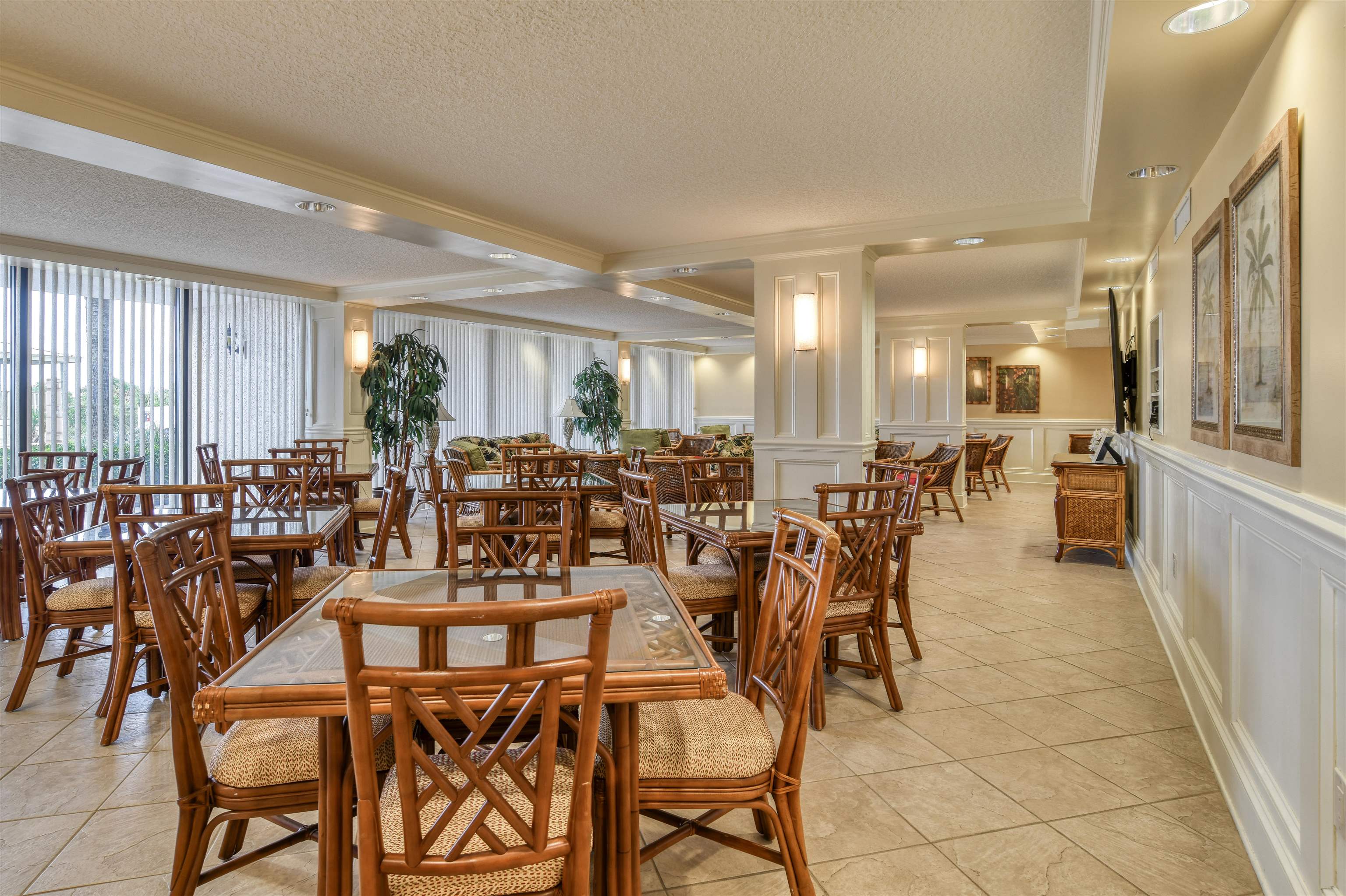 2 Dondanville Road, Unit 101 St. Augustine, FL 32080 - Photo 44 of 50 a room with lots of chairs a desk and large windows