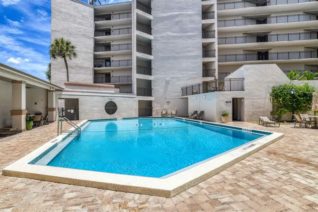 a view of a swimming pool with a lounge chairs