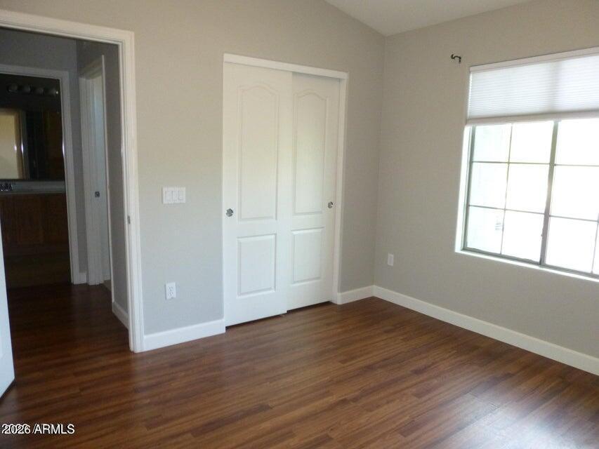 2727 North Price Road, Unit 28 Chandler, AZ 85224 - Photo 11 of 14 an empty room with wooden floor and windows