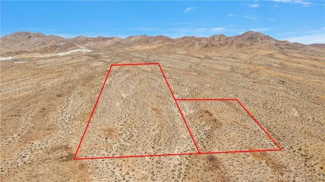 a view of a mountain range in a cloudy sky