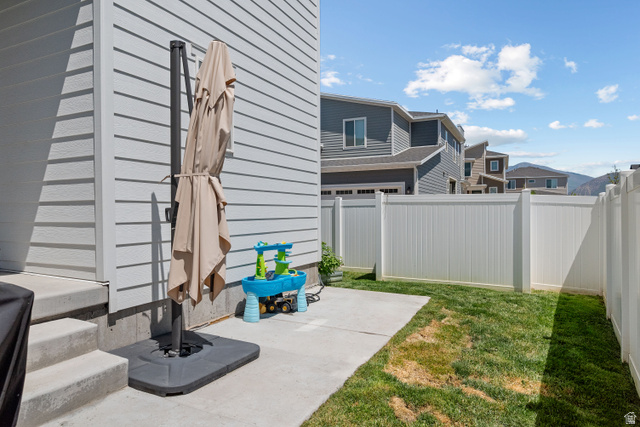 1708 North 1280th Street East Payson, UT 84651 - Photo 13 of 15 Private backyard with a concrete patio, green lawn, and white vinyl fencing