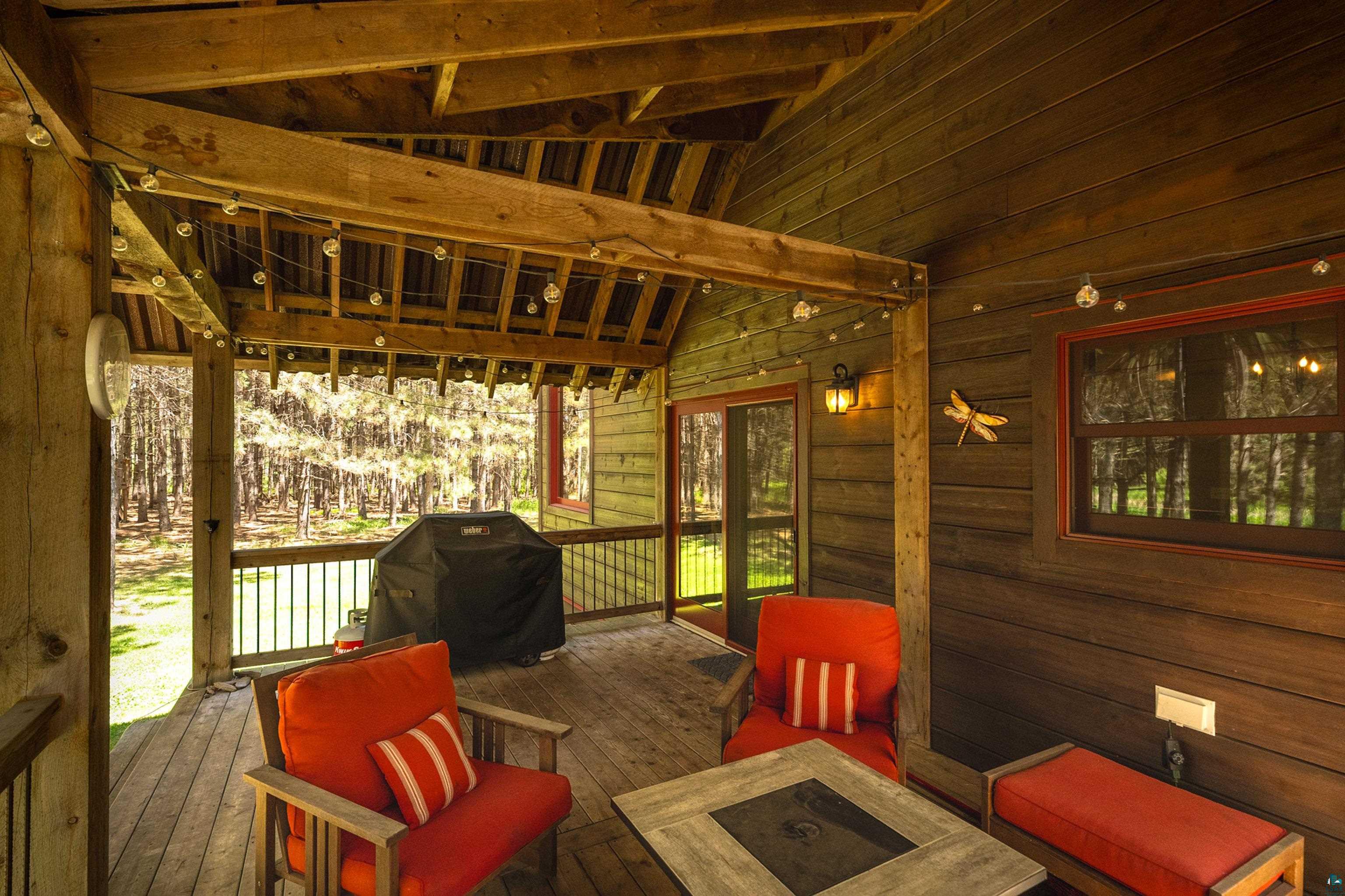 75 East Stark Road Esko, MN 55733 - Photo 65 of 87 Expansive covered porch featuring exposed wood beams and wood-finish flooring