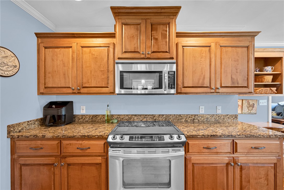 1010 Ridgeview Drive Pendleton, SC 29670 - Photo 18 of 47 This kitchen showcases warm cabinetry, granite countertops, and modern stainless steel appliances.