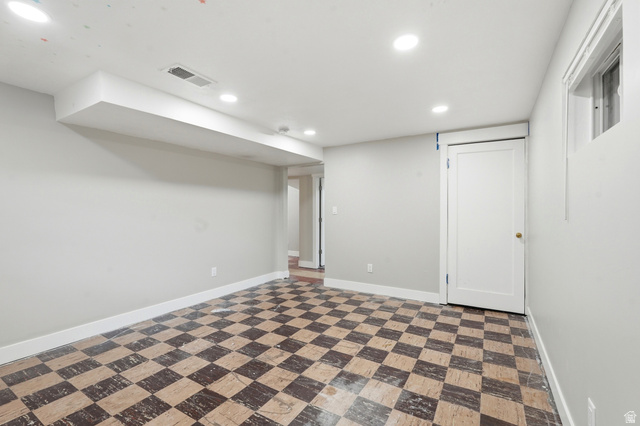 778 East 200 North Logan, UT 84321 - Photo 17 of 43 Spacious room featuring checkerboard tile flooring, recessed ceiling lighting, a white panel door, and a high-set window