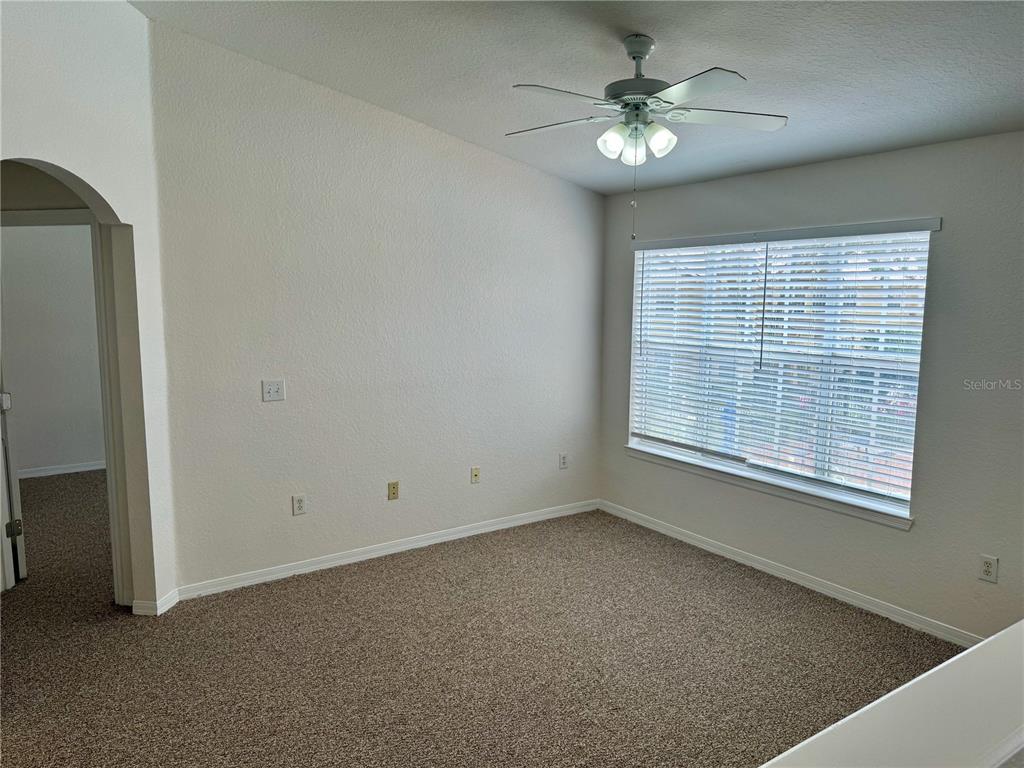 832 Grand Regency Point, Unit 204 Altamonte Springs, FL 32714 - Photo 13 of 19 an empty room with chandelier fan and windows