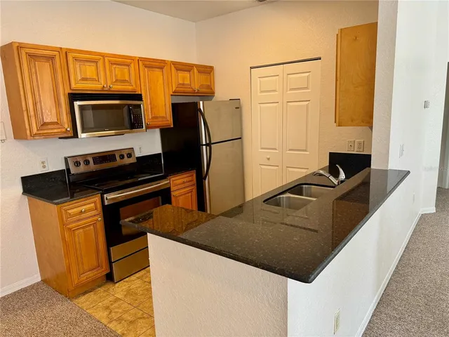 a kitchen with a sink and a stove
