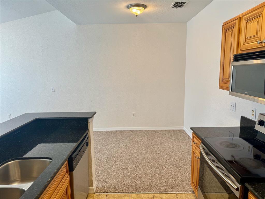 832 Grand Regency Point, Unit 204 Altamonte Springs, FL 32714 - Photo 8 of 19 a kitchen with a sink and a stove