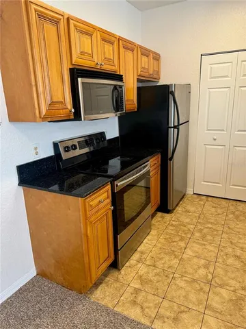 a kitchen with stainless steel appliances granite countertop a sink and cabinets