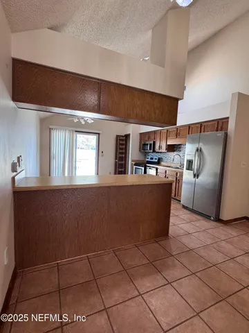 a view of a livingroom with wooden floor a fireplace and window