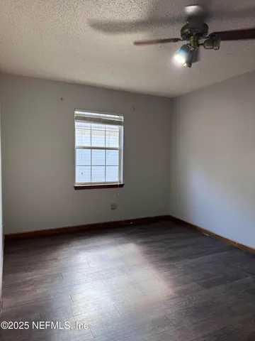 a spacious bathroom with a granite countertop sink a toilet and a bathtub