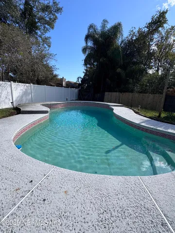 a living room with stainless steel appliances kitchen island granite countertop furniture and a kitchen view