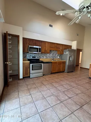 a living room with a couch and a stove top oven