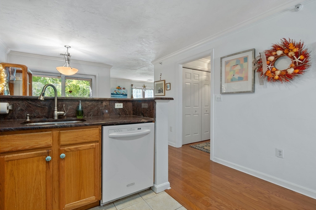 35 Collins Street, Unit 75 Danvers, MA 01923 - Photo 18 of 31 a kitchen with stainless steel appliances granite countertop a refrigerator and a sink