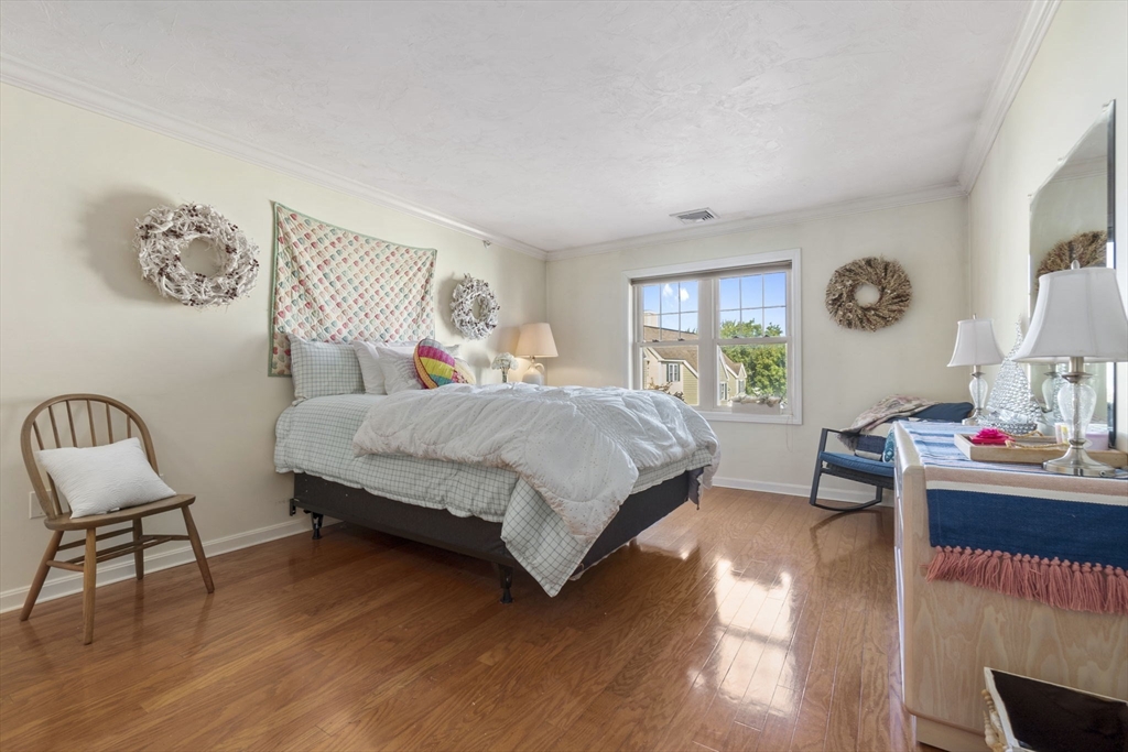 35 Collins Street, Unit 75 Danvers, MA 01923 - Photo 20 of 31 a bedroom with a bed and a chair in it