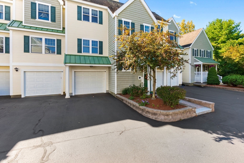 35 Collins Street, Unit 75 Danvers, MA 01923 - Photo 3 of 31 a front view of a house with a yard and garage