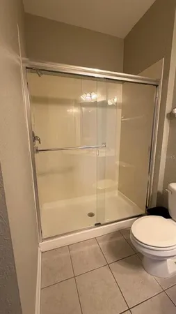 a bathroom with a shower and a toilet