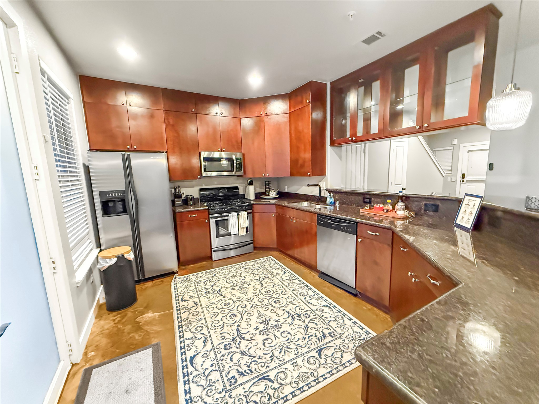 2216 Chenevert Street, Unit 4 Houston, TX 77003 - Photo 7 of 23 a kitchen with stainless steel appliances granite countertop sink stove refrigerator and cabinets