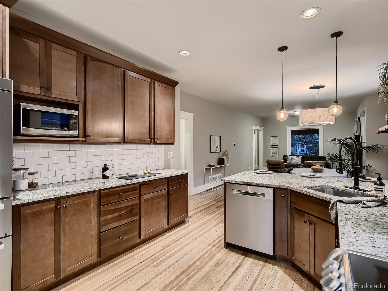 1031 Harrison Street Denver, CO 80206 - Photo 12 of 32 a kitchen with lots of counter top space sink and appliances