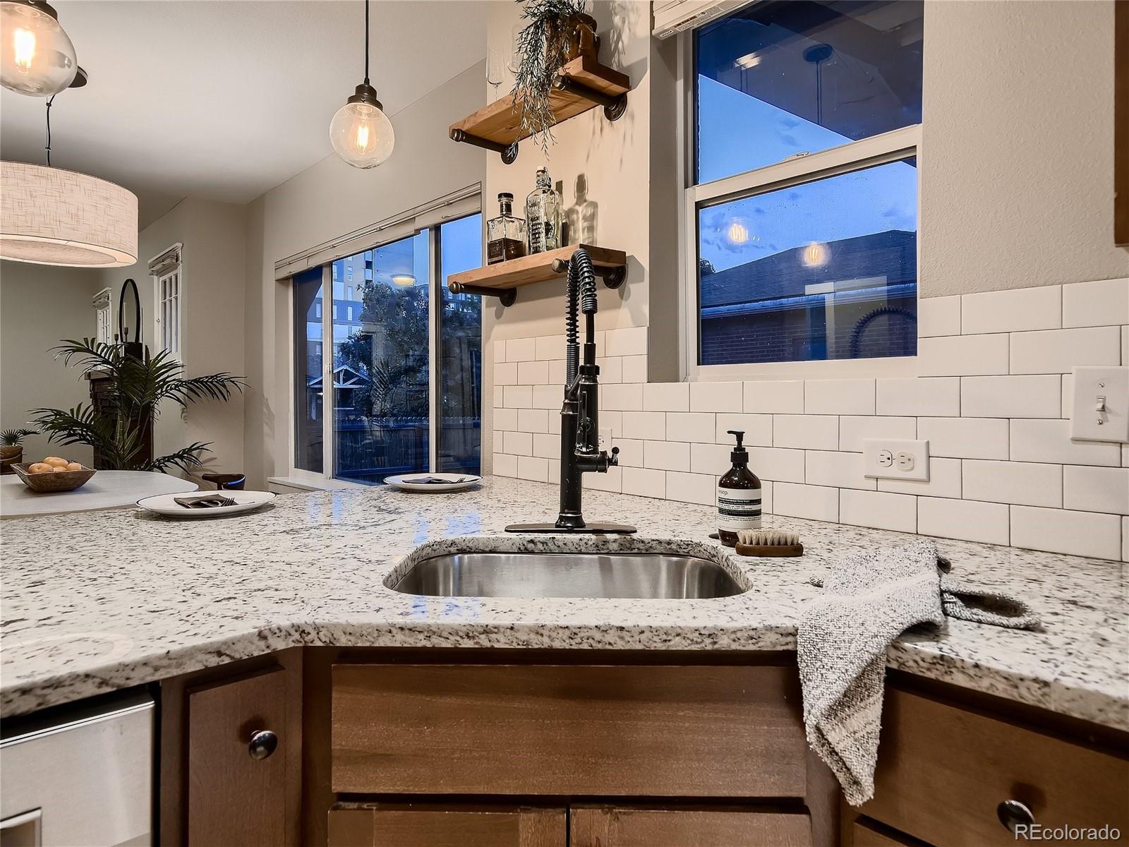 1031 Harrison Street Denver, CO 80206 - Photo 13 of 32 a kitchen with granite countertop a sink and a stove