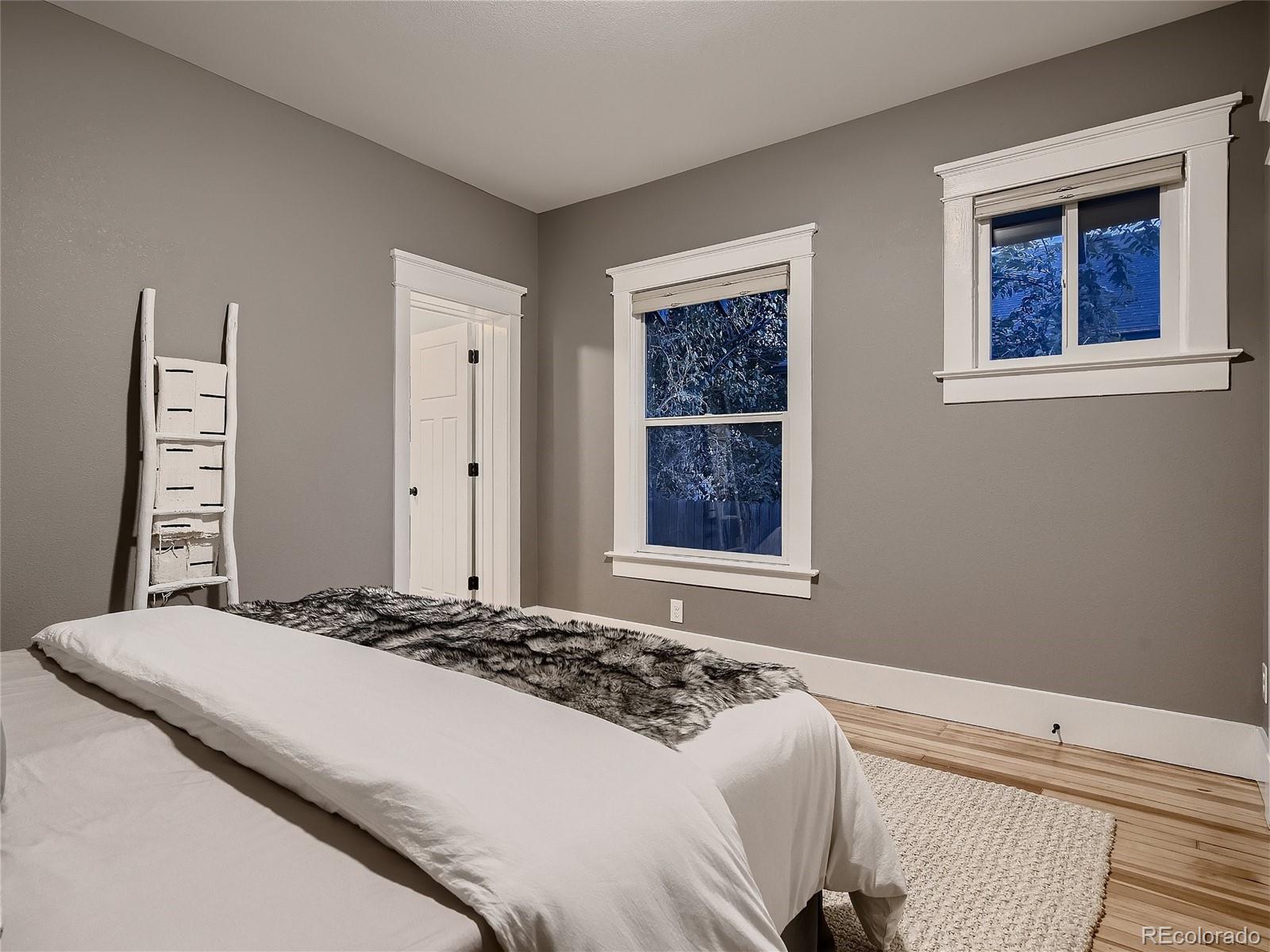 1031 Harrison Street Denver, CO 80206 - Photo 16 of 32 a bedroom with a bed and a window