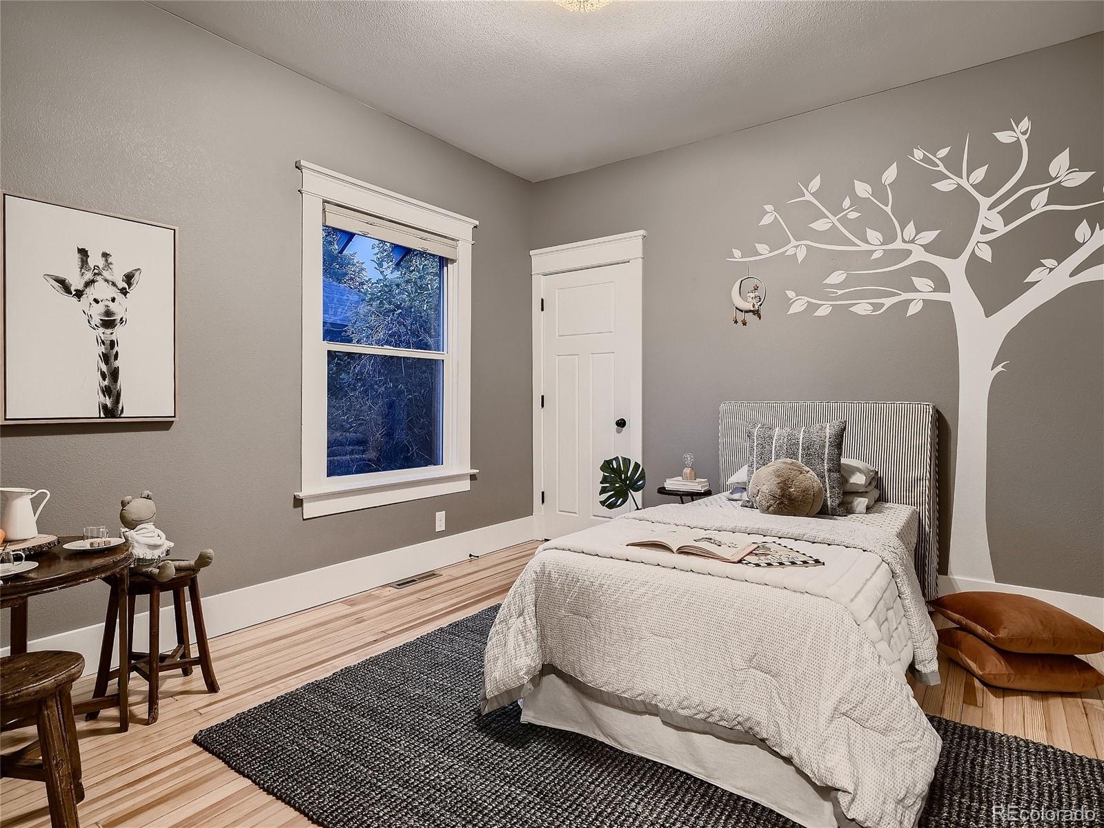 1031 Harrison Street Denver, CO 80206 - Photo 20 of 32 a bedroom with a bed and a window