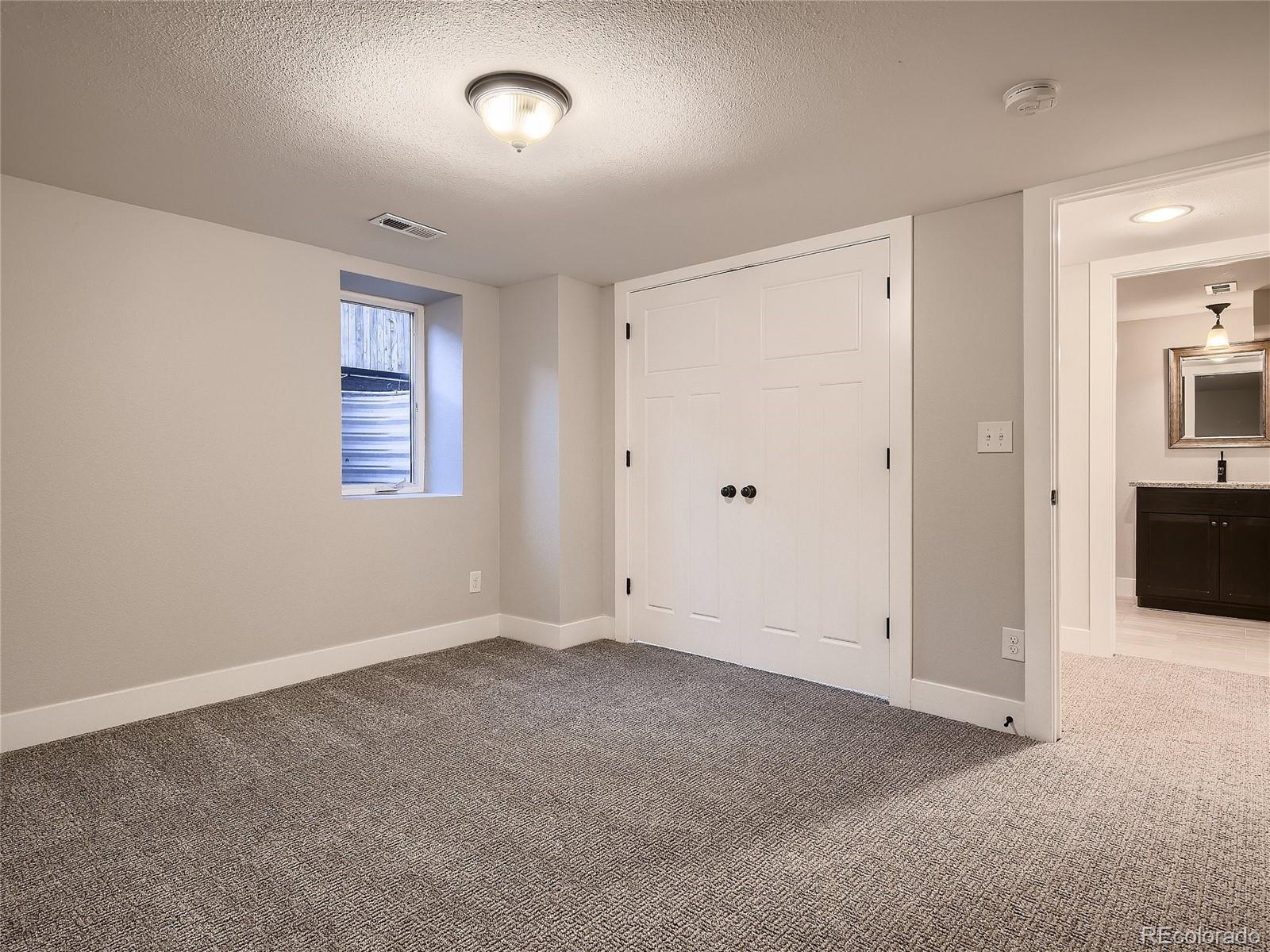 1031 Harrison Street Denver, CO 80206 - Photo 24 of 32 a view of an empty room with a window