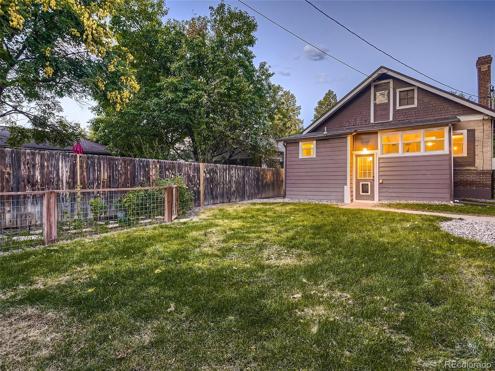 1031 Harrison Street Denver, CO 80206 - Photo 31 of 32 a front view of a house with a yard