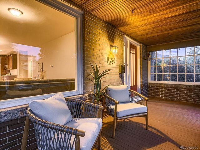 a view of a hallway with wooden floor and entryway