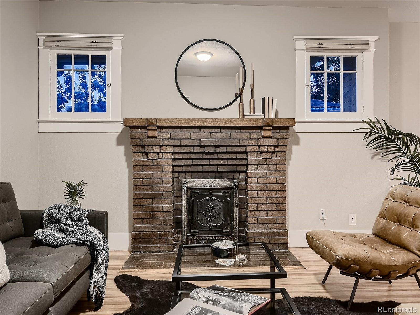 1031 Harrison Street Denver, CO 80206 - Photo 7 of 32 a living room with furniture a window and a fireplace