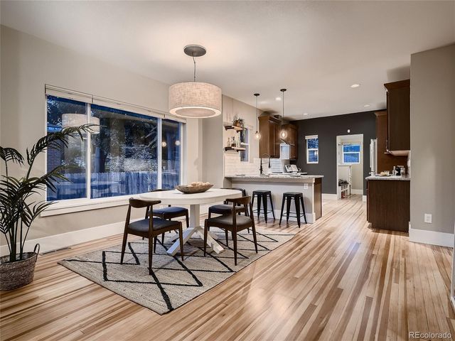 a kitchen with granite countertop a sink stove and refrigerator