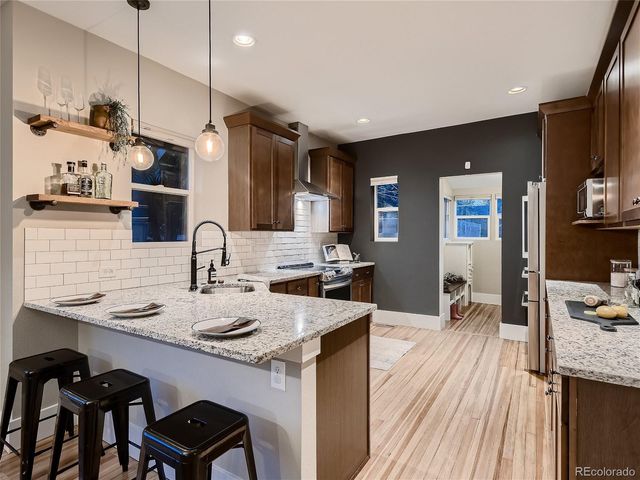 a kitchen with stainless steel appliances granite countertop a stove and a sink