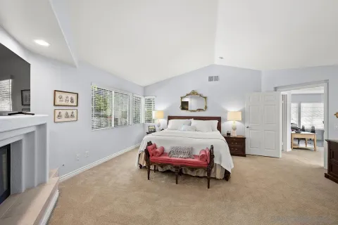 a bedroom with a bed and table chair