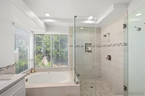 a bathroom with a shower and a bathtub