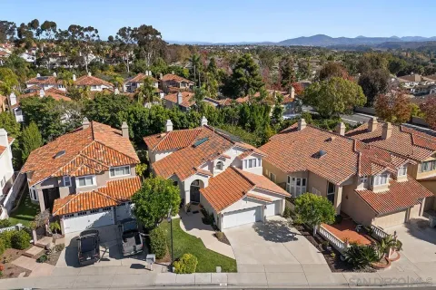 an aerial view of a houses with a city street