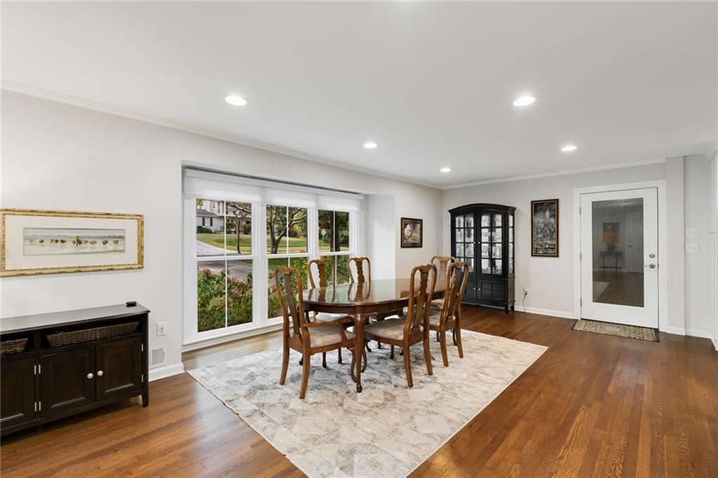 6555 Wright Road Northeast Sandy Springs, GA 30328 - Photo 11 of 40 a view of a dining room with furniture and wooden floor