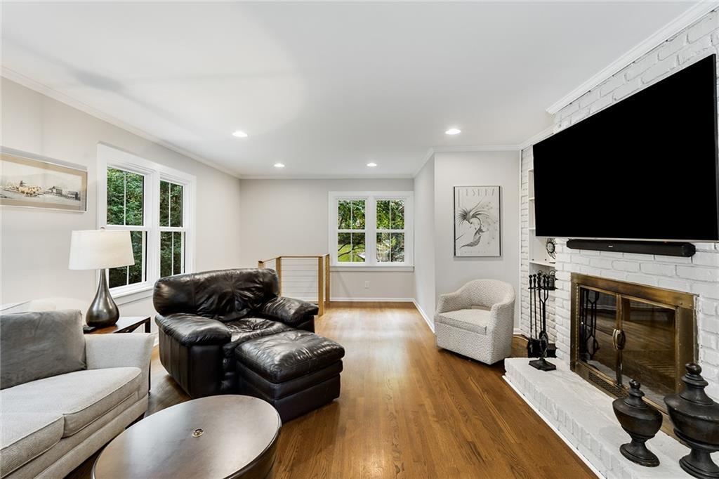 6555 Wright Road Northeast Sandy Springs, GA 30328 - Photo 15 of 40 a living room with furniture a fireplace and a flat screen tv