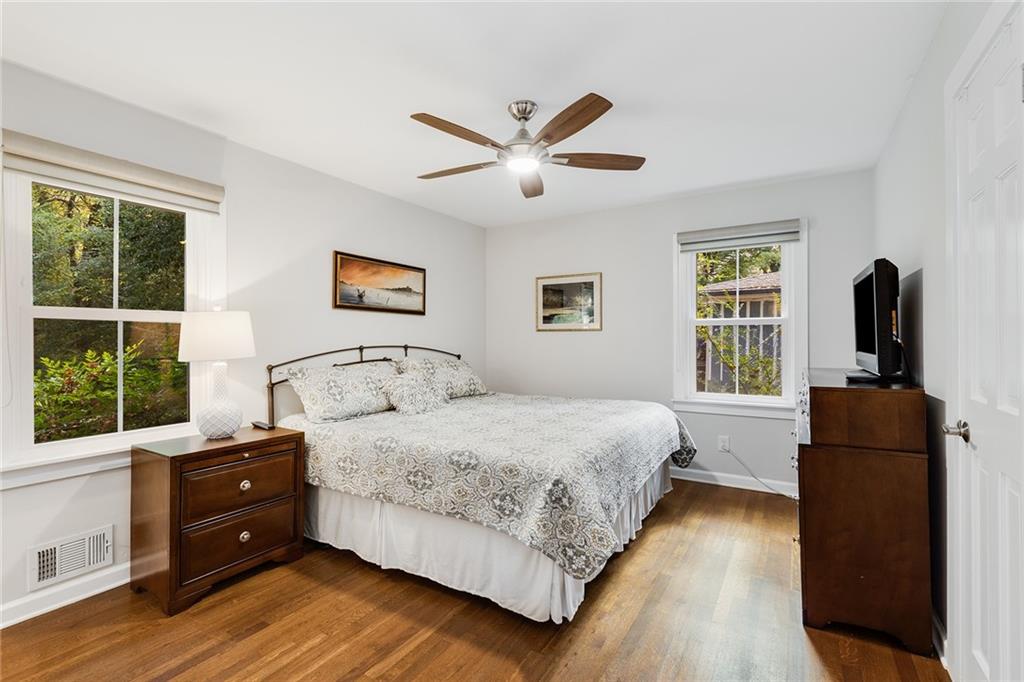 6555 Wright Road Northeast Sandy Springs, GA 30328 - Photo 18 of 40 a bedroom with a bed and wooden floor