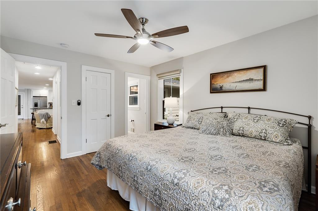 6555 Wright Road Northeast Sandy Springs, GA 30328 - Photo 19 of 40 a bedroom with a large bed and a chandelier