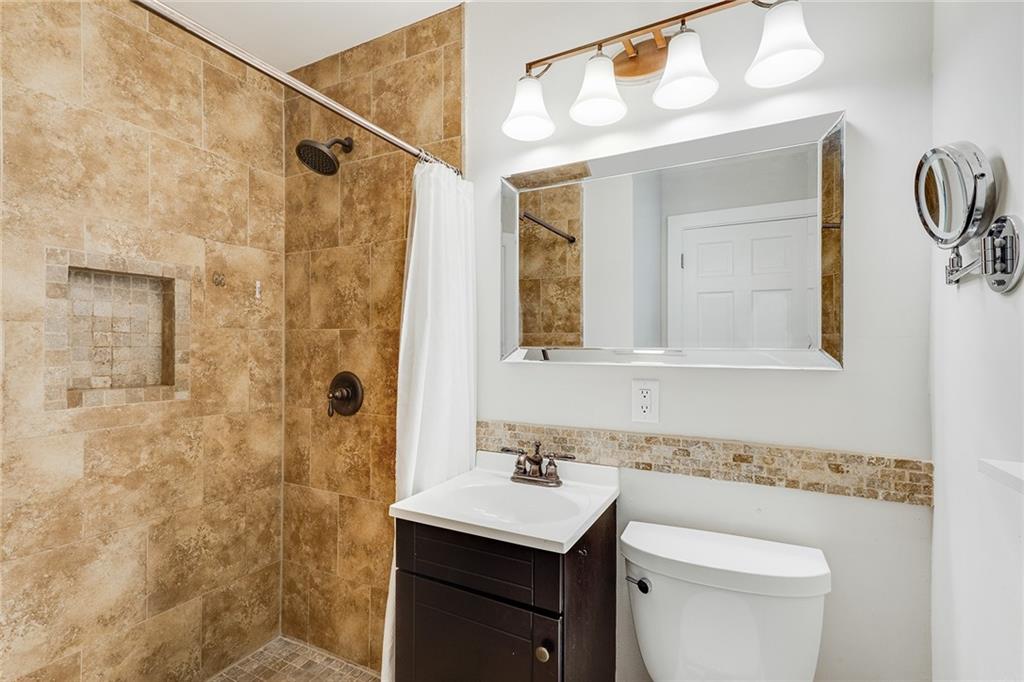6555 Wright Road Northeast Sandy Springs, GA 30328 - Photo 20 of 40 a bathroom with a sink a toilet and shower