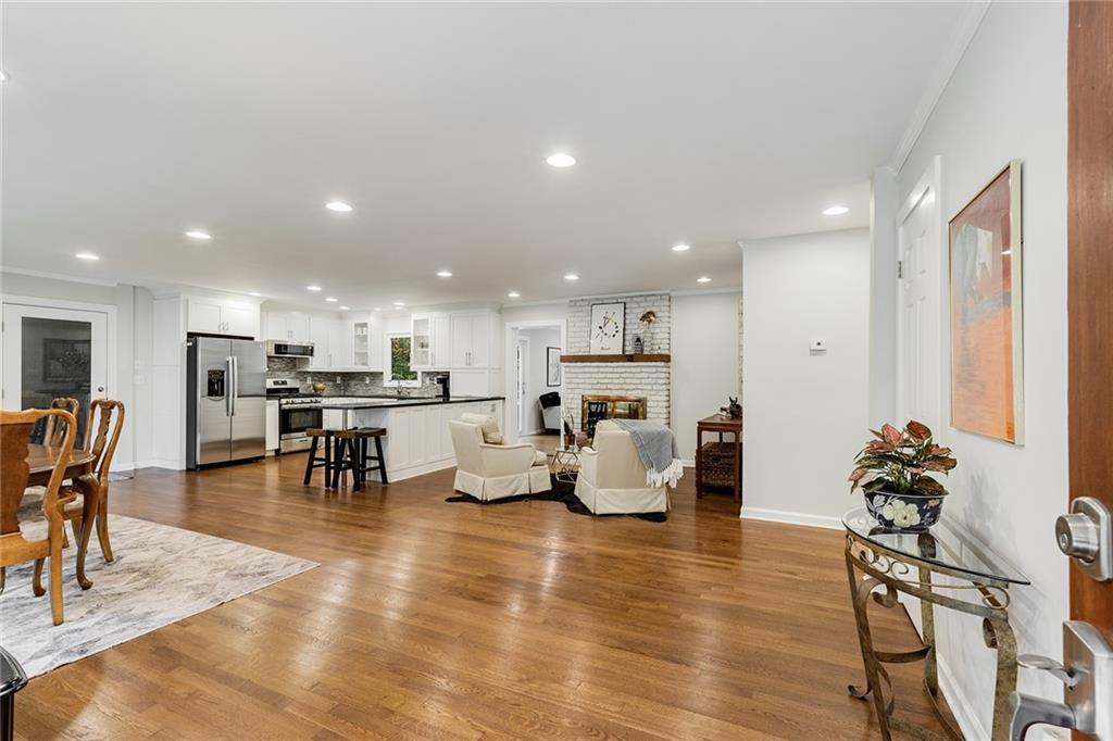 6555 Wright Road Northeast Sandy Springs, GA 30328 - Photo 2 of 40 a living room with furniture and a dining table with kitchen view