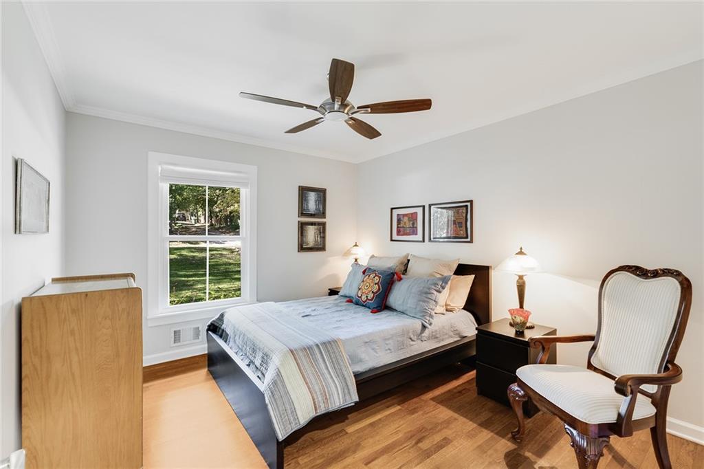 6555 Wright Road Northeast Sandy Springs, GA 30328 - Photo 21 of 40 a bedroom with a bed chair and window