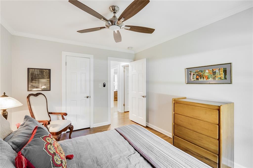 6555 Wright Road Northeast Sandy Springs, GA 30328 - Photo 22 of 40 a bed room with a bed and a dresser