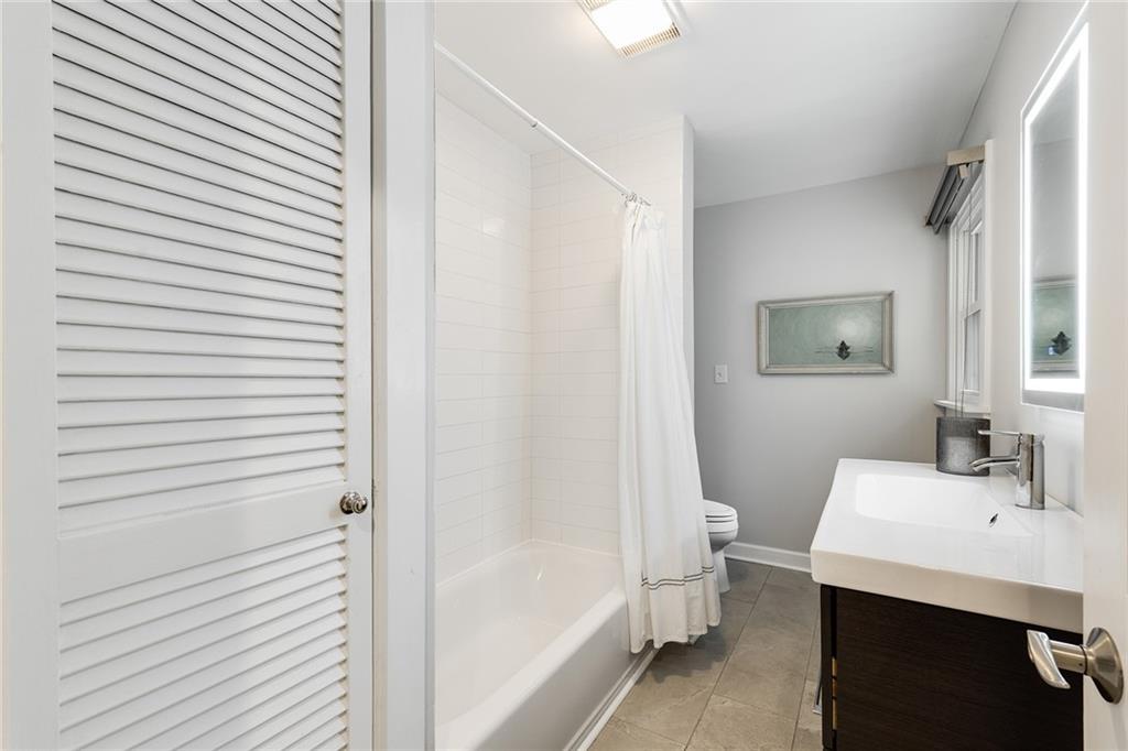 6555 Wright Road Northeast Sandy Springs, GA 30328 - Photo 23 of 40 a bathroom with a sink a toilet and shower