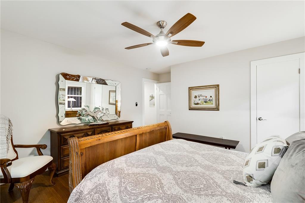 6555 Wright Road Northeast Sandy Springs, GA 30328 - Photo 26 of 40 a bedroom with a bed and a chandelier