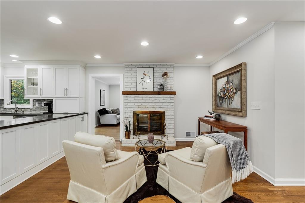6555 Wright Road Northeast Sandy Springs, GA 30328 - Photo 3 of 40 a living room with fireplace furniture and a wooden floor
