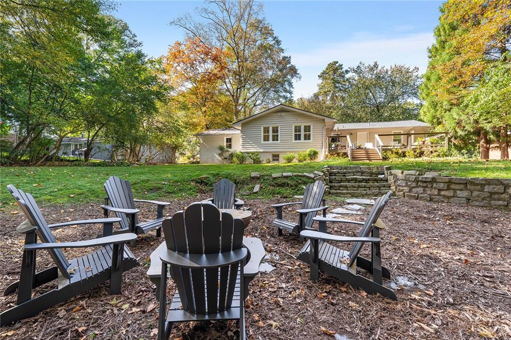 6555 Wright Road Northeast Sandy Springs, GA 30328 - Photo 31 of 40 a view of a house with backyard wooden deck and outdoor seating