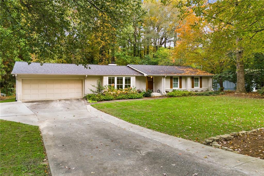 6555 Wright Road Northeast Sandy Springs, GA 30328 - Photo 37 of 40 a front view of a house with a yard